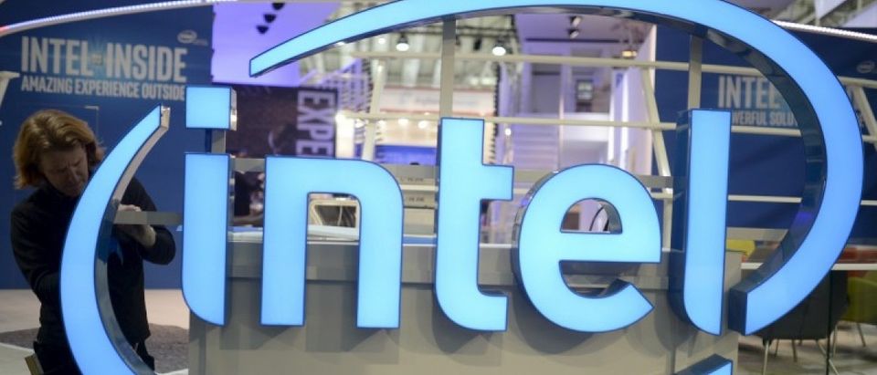 File photo of a worker arranging Intel logo at CeBIT trade fair in Hannover