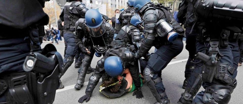 French riot police officers detain a protestor during a demonstration against the French labor law proposal in Lyon, France, as part of a nationwide labor reform protests and strikes, April 28, 2016. REUTERS/Robert Pratta