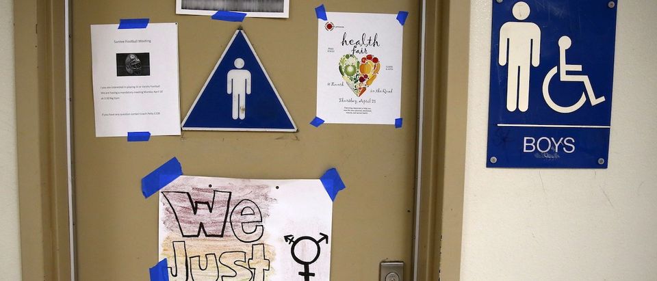 A protest sign on a bathroom which helped lobby for the first gender-neutral restroom in the Los Angeles school district is seen at Santee Education Complex high school in Los Angeles, California, U.S., April 18, 2016. (REUTERS/Lucy Nicholson)