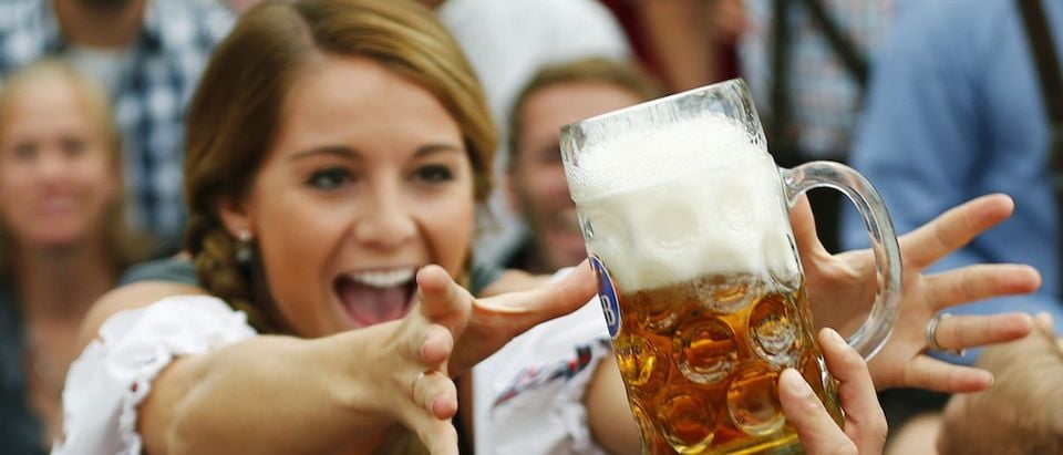 File photo of a visitor reaching for of the one of the first mugs of beer after the tapping of the first barrel during the opening ceremony for the 180th Munich Oktoberfest