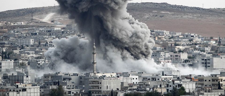 Heavy smoke rises following an airstrike by the US-led coalition aircraft in Kobani, Syria, during fighting between Syrian Kurds and the militants of Islamic State group, as seen from the outskirts of Suruc, on the Turkey-Syria border, October 18, 2014. (Gokhan Sahin/Getty Images)
