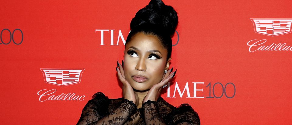 Recording artist Nicki Minaj poses for photographers on the red carpet as she arrives for the TIME 100 Gala in Manhattan