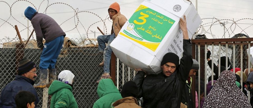 Syrian refugees receive aid packages at Al Zaatari refugee camp