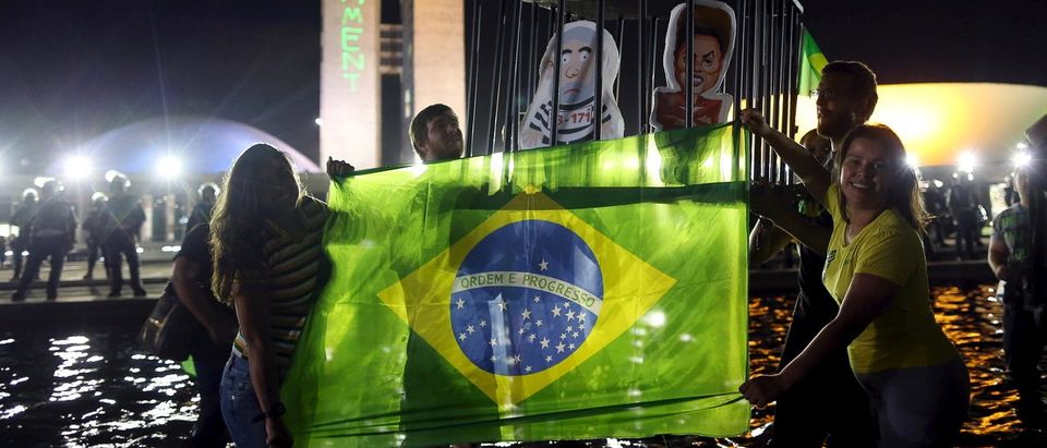Demonstrators displays inflatable dolls of Brazilian President Dilma Rousseff and former President Luiz Inacio Lula da Silva d in Brasilia