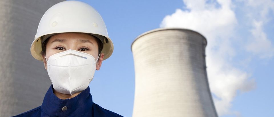 Worker with hardhat and mask at nuclear power plant. (Shuttershock)