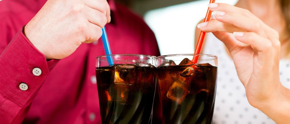 Couple drinking soda in a bar or restaurant (Credit: Kzenon/Shutterstock)