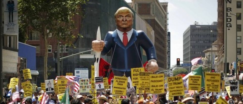 People march with an inflatable effigy of Republican presidential candidate Donald Trump during an immigrant rights May Day rally in Los Angeles