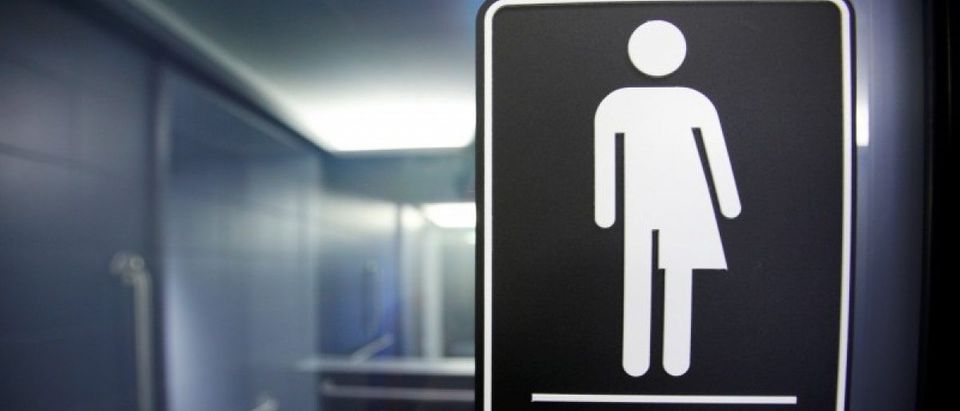 A sign protesting a recent North Carolina law restricting transgender bathroom access adorns the bathroom stalls at the 21C Museum Hotel in Durham, North Carolina May 3, 2016. REUTERS/Jonathan Drake