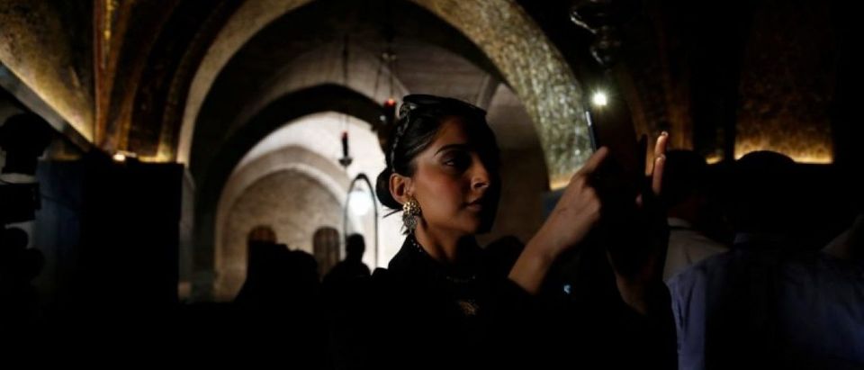 Indian actress Sonam Kapoor takes a photograph during her visit to the Church of the Holy Sepulchre in Jerusalem's Old City