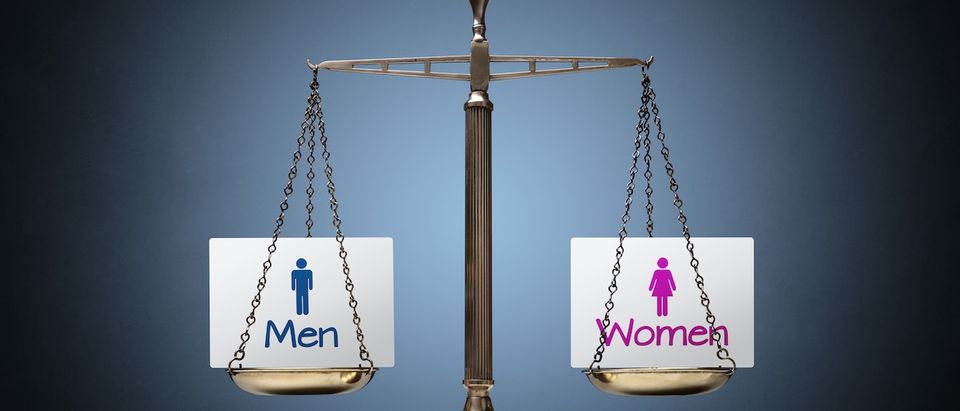 Equality between man and woman concept with beam scales and sign