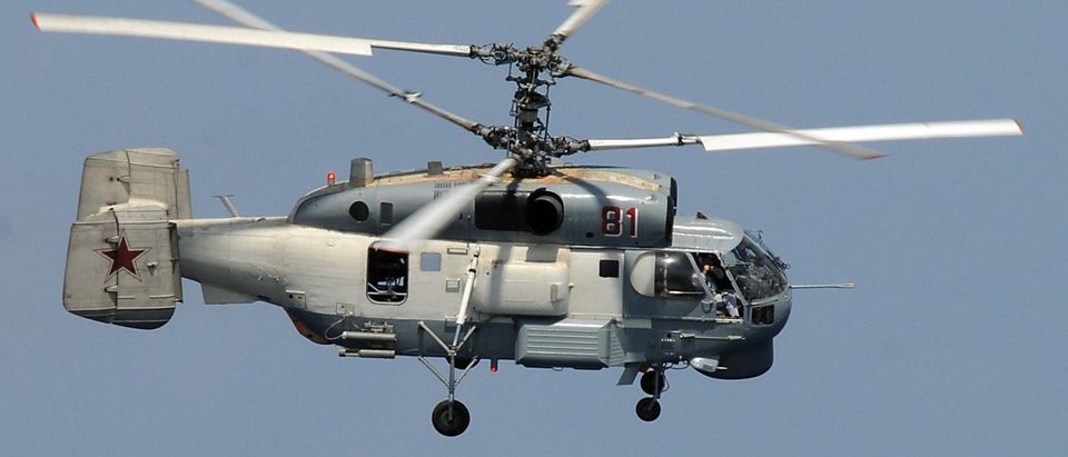 A Russian Helix KA-27 helicopter flies near the guided-missile cruiser USS Vella Gulf in this US Navy file photo