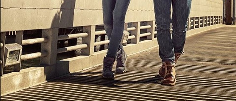 A man and a woman walk in Timberlands (Photo via Amazon/Timberland)