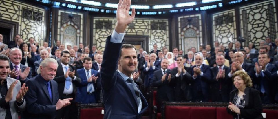 Syria's president Bashar al-Assad gestures while parliament members clap in Damascus, Syria in this handout picture provided by SANA on June 7, 2016. SANA/Handout