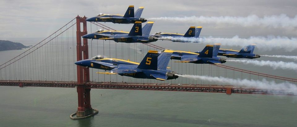 The U.S. Navy's Blue Angels fly in a Delta formation past the Golden Gate Bridge during a practice run in preparation for Fleet Week air show in San Francisco
