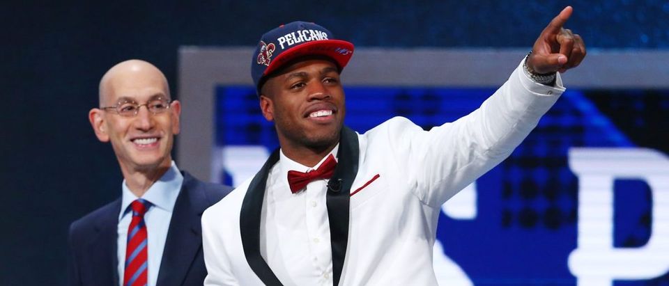 Buddy Hield (Oklahoma) gestures while next to NBA commissioner Adam Silver after being selected as the number six overall pick to the New Orleans Pelicans in the first round of the 2016 NBA Draft at Barclays Center