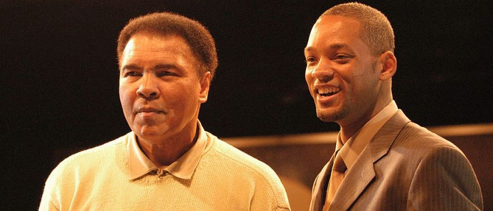 Boxing legend Muhammad Ali stands with actor Will Smith at the Miami Art Basel Taschen book premiere of Ali's new book, "GOAT - Greatest Of All Time" at the Miami Convention Center December 6, 2003 in Miami