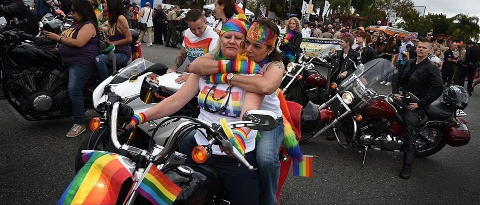 Participants take part in the 2016 Gay Pride Parade in West Hollywood, California on June 12, 2016. Security for the tightened in the aftermath of the deadly shootings June 12 at the Pulse, a packed gay nightclub in Orlando, Florida. / AFP / Mark Ralston (Photo credit should read MARK RALSTON/AFP/Getty Images)