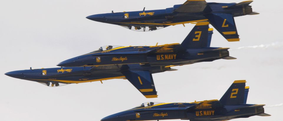 U.S. Navy Flight Demonstration Squadron, the Blue Angels, fly in tight formation as they practice routines in F/A-18 Hornet fighter jets on rehearsal day for the Los Angeles County Air Show in Lancaster