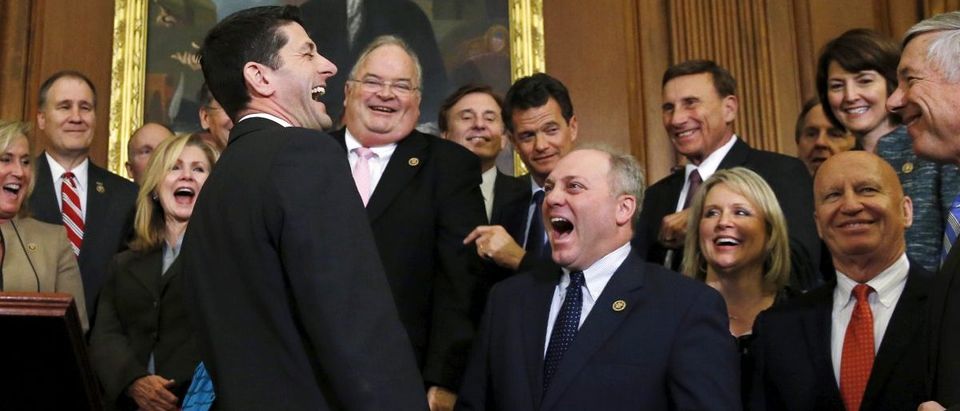 House Speaker Paul Ryan laughs with fellow House Republicans after signing a bill repealing Obamacare at the U.S. Capitol in Washington January 7, 2016