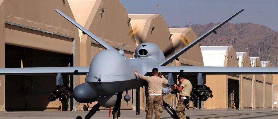 U.S. airmen prepare a U.S. Air Force MQ-9 Reaper drone as it leaves on a mission at Kandahar Air Field