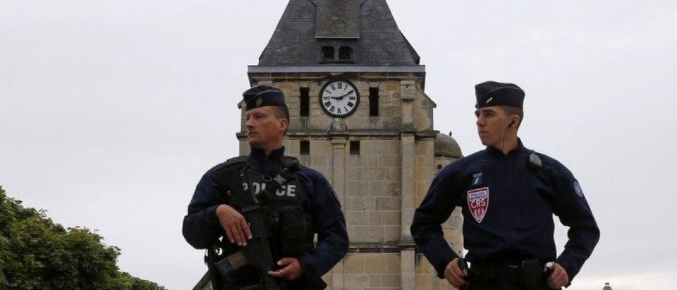 French CRS police stand guartd in front of the church a day after a hostage-taking in Saint-Etienne-du-Rouvray near Rouen in Normandy