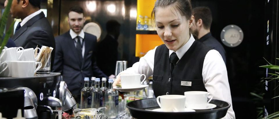 A waitress works at the bar on the stand of Hyatt Hotels Corporation during the International Tourism Trade Fair in Berlin