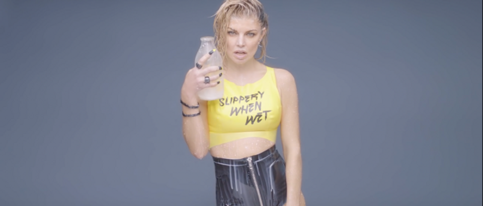 Fergie dowses herself in milk (Photo: YouTube)