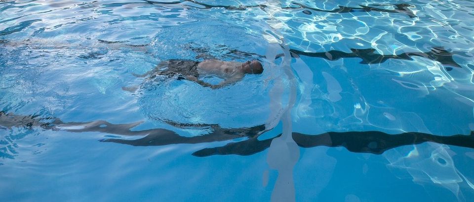 A man swims in a pool at kibbutz Nir Oz near the border with the Gaza Strip