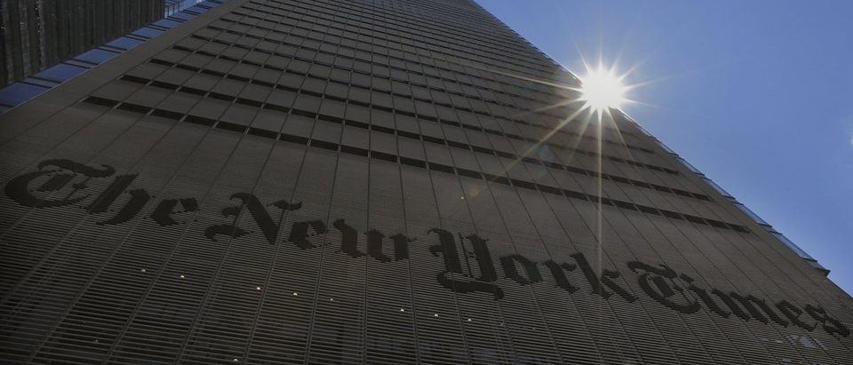 The sun peaks over the New York Times Building in New York August 14, 2013. REUTERS/Brendan McDermid