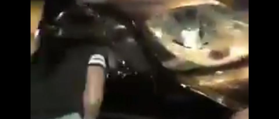 Rioters in Milwaukee smash up a car. [Twitter video screengrab/https://twitter.com/CrashnDaPlane/status/764690612016652288/video/1]