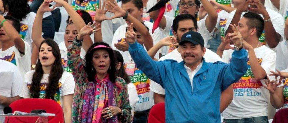 President Daniel Ortega and first lady Rosario Murillo greet supporters during celebrations to mark the 37th anniversary of the Sandinista Revolution at the Juan Pablo II square in Managua