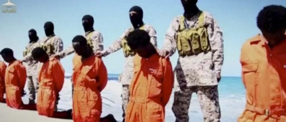 Islamic State militants stand behind what are said to be Ethiopian Christians along a beach in Wilayat Barqa, in this still image from an undated video made available on a social media website