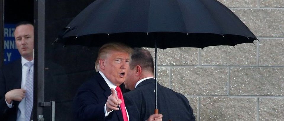 Republican presidential nominee Donald Trump arrives in the rain for a campaign rally in Tampa