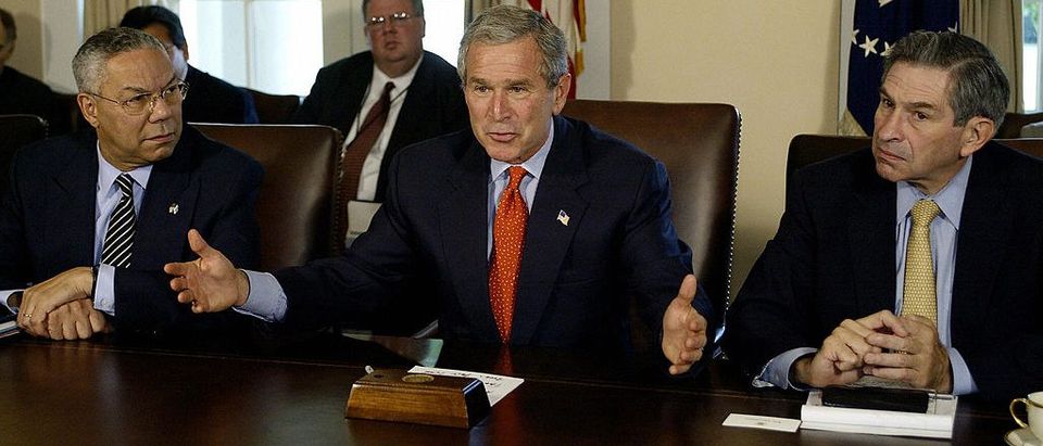 US President George W. Bush(C) delivers a few words to the media on the growth of the economy before a Cabinet meeting 07 October, 2003 at the White House in Washington, DC. US Secretary of State Colin Powell(L) and Deputy Secretary of Defense Paul Wolfowitz(R) look on. PAUL J.RICHARDS/AFP/Getty Images
