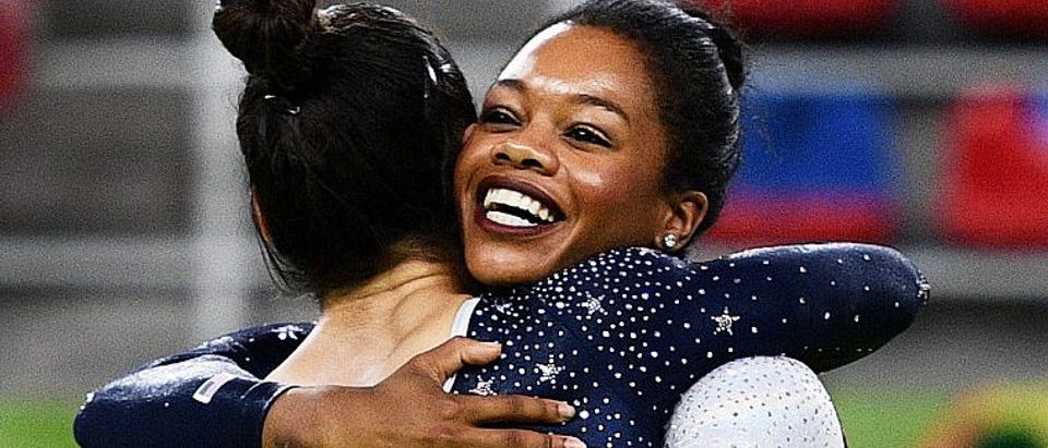 Alexandra Raisman (L) and Gabrielle Douglas (R) of the United States celebrate winning the gold medal during the Artistic Gymnastics Women's Team Final on Day 4 of the Rio 2016 Olympic Games at the Rio Olympic Arena on August 9, 2016 in Rio de Janeiro, Brazil