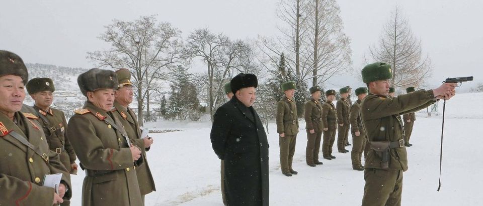 North Korean leader Kim Jong Un stands in the snow as he inspects KPA Unit 1313 honored with the title of O Jung Hup-led 7th Regiment