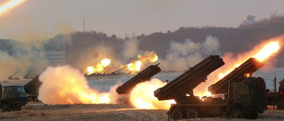 Multiple rocket launchers are seen being fired during a military drill at an unknown location, in this undated photo released by North Korea's Korean Central News Agency (KCNA)