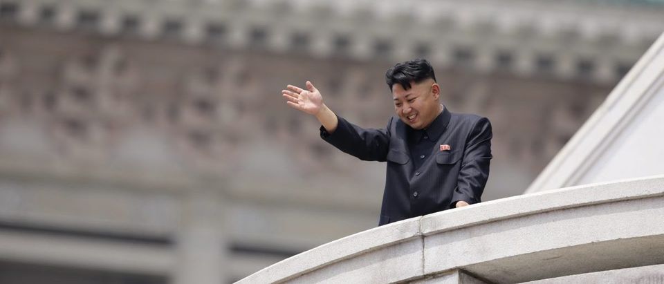 North Korean leader Kim Jong-un waves to the people during a parade in Pyongyang