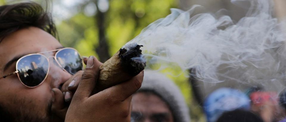 A man smokes marijuana during a rally for the legalization of marijuana in Mexico City, Mexico, May 7, 2016. REUTERS/Henry Romero