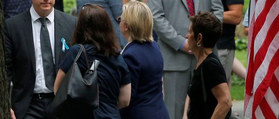 U.S. Democratic presidential candidate Hillary Clinton leaves ceremonies marking the 15th anniversary of the September 11 attacks at the National 9/11 Memorial in New York