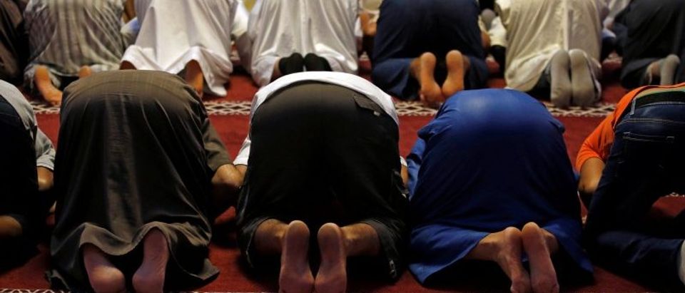 Members of the Muslim community pray during Friday prayers inside the mosque in Frejus