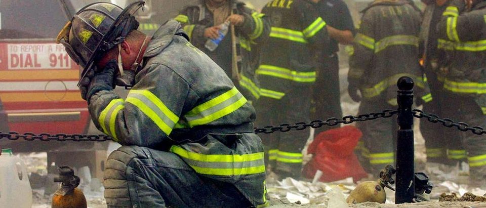 A firefighter breaks down after the World Trade Center buildings collapsed September 11, 2001 after two hijacked airplanes slammed into the twin towers in a terrorist attack. (Photo by Mario Tama/Getty Images)