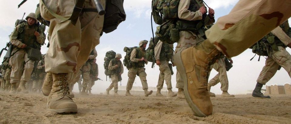 U.S. Marines from the 1st Marine Division return from a six-mile march February 15, 2003 near the Iraqi border in Kuwait. The Marines continue to prepare for a possible military strike against Iraq. (Joe Raedle/Getty Images)