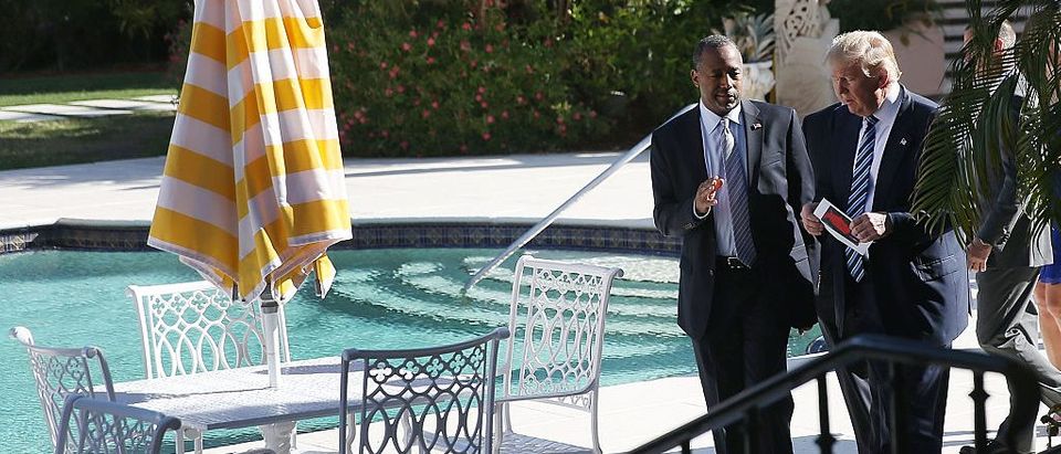 Donald Trump walks with Ben Carson before he receives his endorsement at the Mar-A-Lago Club on March 11, 2016 in Palm Beach, Florida (Getty Images)
