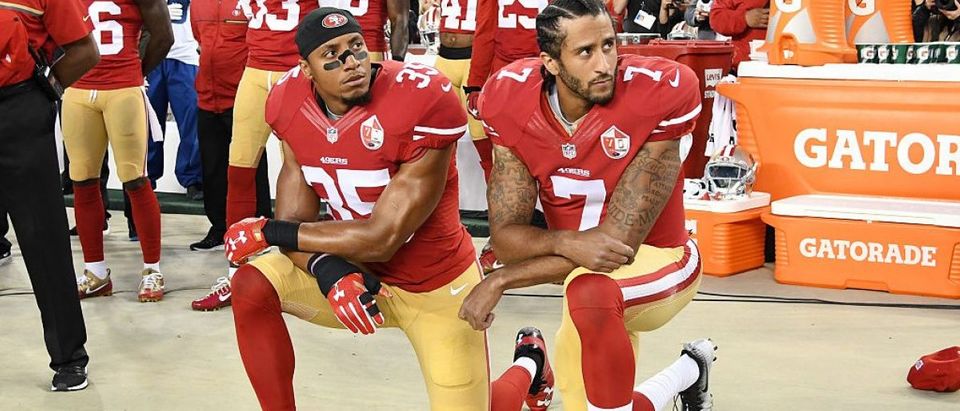 Colin Kaepernick #7 and Eric Reid #35 of the San Francisco 49ers kneel in protest during the national anthem prior to playing the Los Angeles Rams in their NFL game at Levi's Stadium on September 12, 2016 in Santa Clara, California