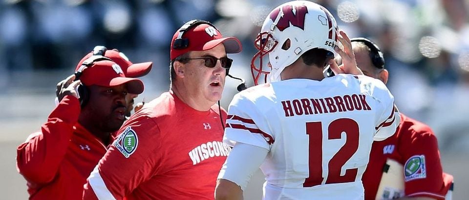 Paul Chryst, head coach of the Wisonsin Badgers, talks to Alex Hornibrook #12 of the Wisconsin Badgers during the game against the Michigan State Spartans at Spartan Stadium on September 24, 2016 in East Lansing, Michigan. (Photo by Bobby Ellis/Getty Images)