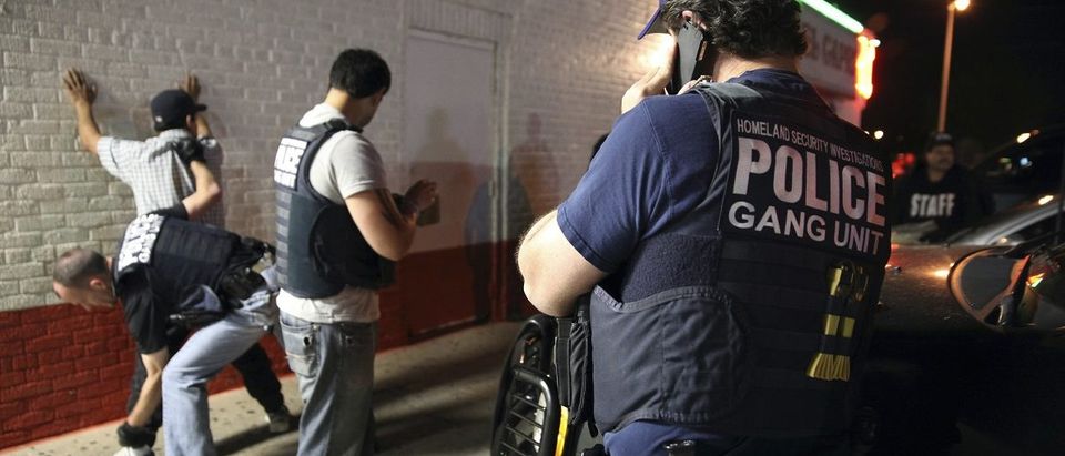 Federal agents with ICE detain a man during Project Southbound sweep for suspected gang members, in Dallas, Texas