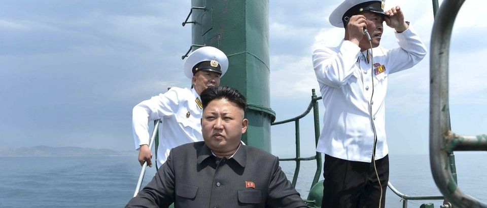 North Korean leader Kim Jong Un stands on the conning tower of a submarine during his inspection of the KPA Naval Unit 167