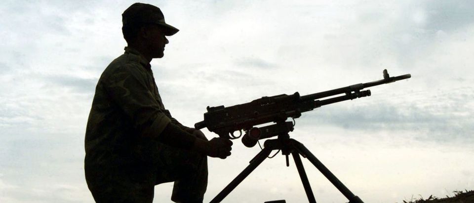 AN INDIAN SOLDIER MANS HIS MACHINE GUN NEAR THE INDIA-PAKISTAN BORDERNEAR AMRITSAR.