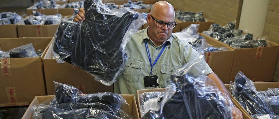 Kevin Finnegan searches through boxes of new bulletproof vests to be handed out to Chicago police officers in Chicago, Illinois, September 14, 2015